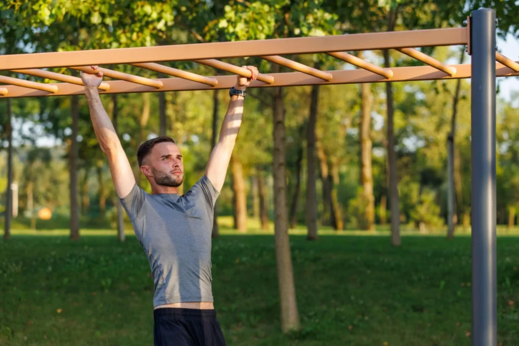 Young Man Overcomes An Obstacle With His Hands During Daily Workou